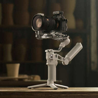 Camera stabilizer on a wooden surface with a blurred background