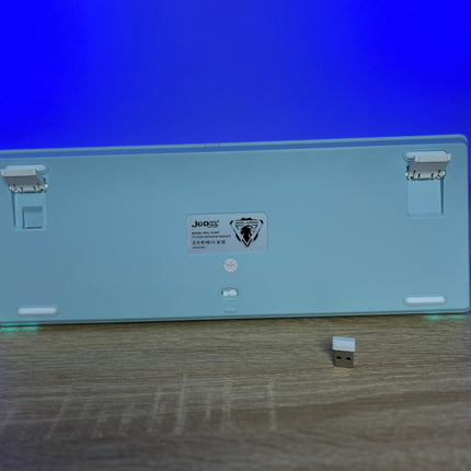 Electronic device with a blue light on a wooden surface