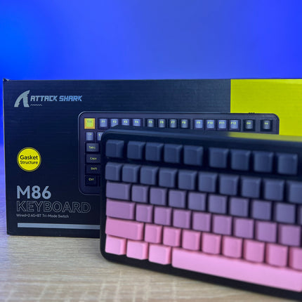 Keyboard with gradient keycaps in front of an Attack Shark branded box.