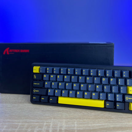 Mechanical keyboard with blue and yellow keys on a blue gradient background