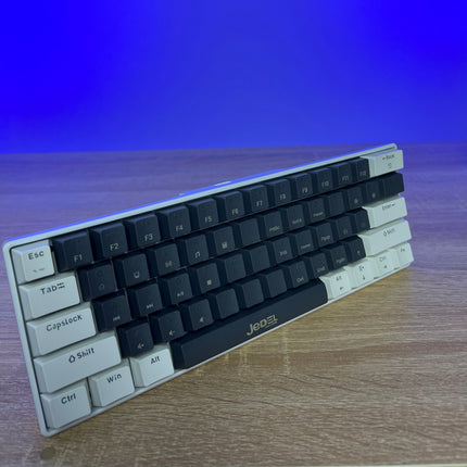 Keyboard on a wooden surface with a blue gradient background