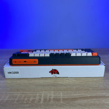 Mechanical keyboard with white keycaps on a wooden surface and blue background