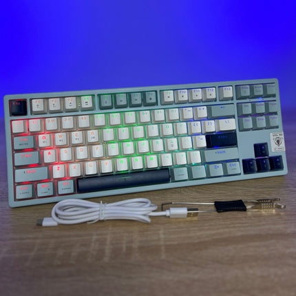 Mechanical keyboard with RGB backlighting on a wooden surface with a blue gradient background
