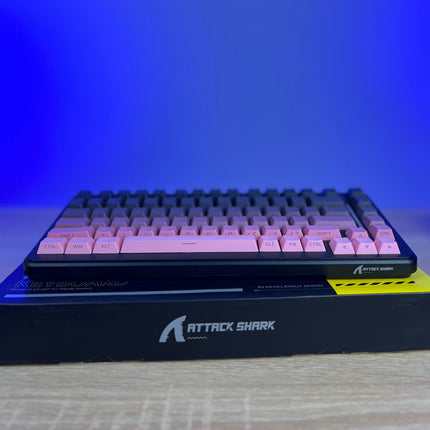 Keyboard with pink keys on a blue gradient background