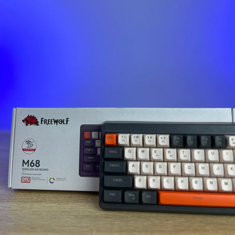 Mechanical keyboard with Freewolf M68 packaging on a blurred background
