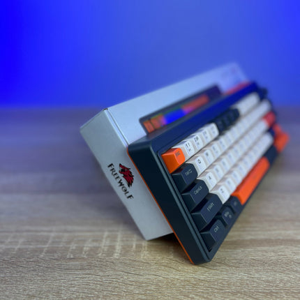 Small electronic device with keyboard-like keys on a wooden surface