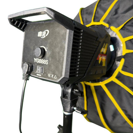 Close-up of a work light with visible branding on a green background