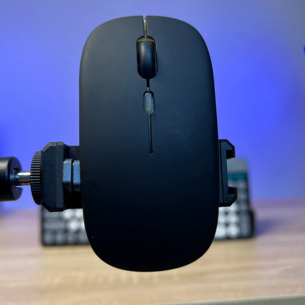 Black gaming mouse on a stand with a blurred background