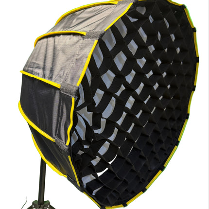 Black and gray octagonal softbox with yellow trim on a green background