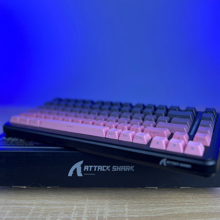 Mechanical keyboard with pink keys on a blue gradient background