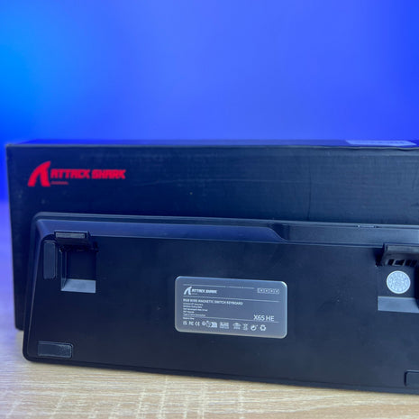 Black electronic device with 'Attack Shark' branding on a blue background