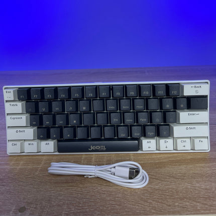 Mechanical keyboard with white frame and black keys on a wooden surface with a blue gradient background.